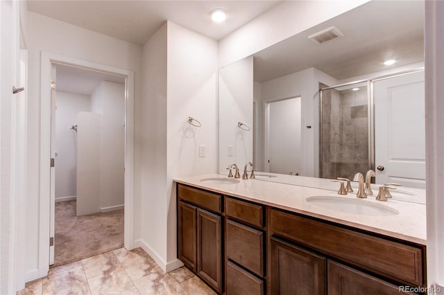 bathroom with vanity and a shower with shower door