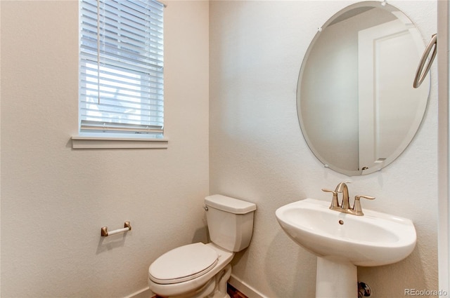 bathroom featuring toilet and sink