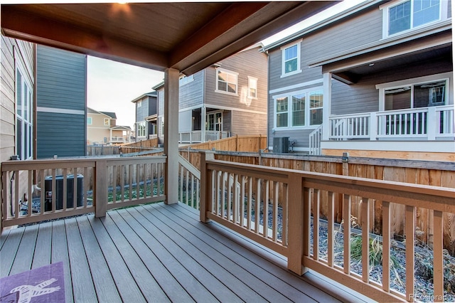 wooden deck featuring cooling unit