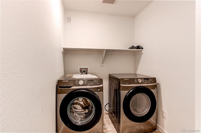 washroom featuring washer and dryer