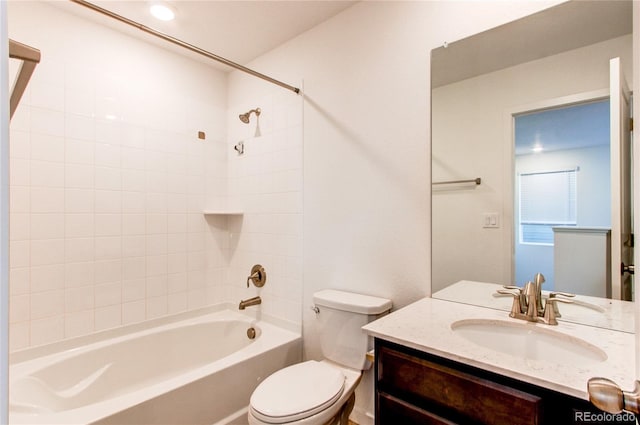 full bathroom with toilet, vanity, and tiled shower / bath