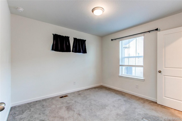 unfurnished room with light colored carpet