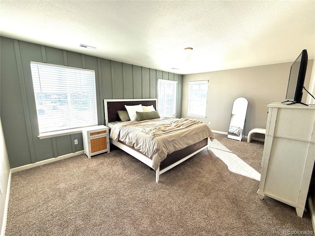 carpeted bedroom with a textured ceiling