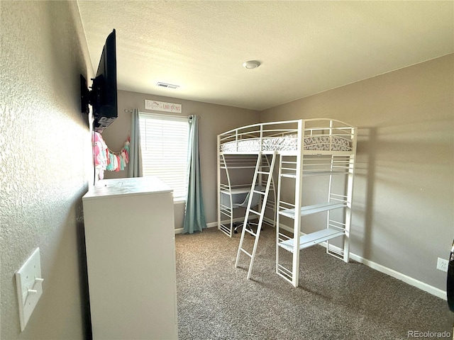 unfurnished bedroom featuring carpet floors and a textured ceiling