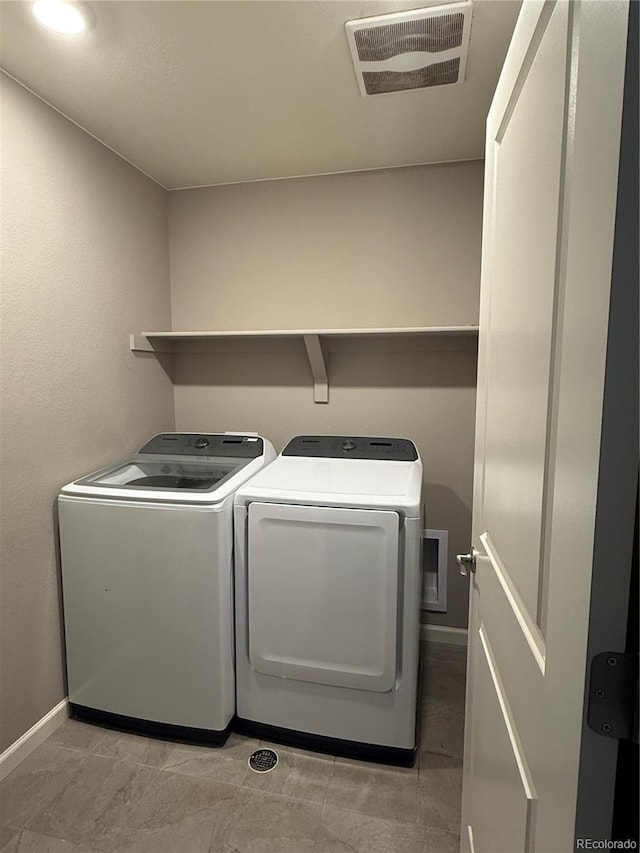 washroom with separate washer and dryer