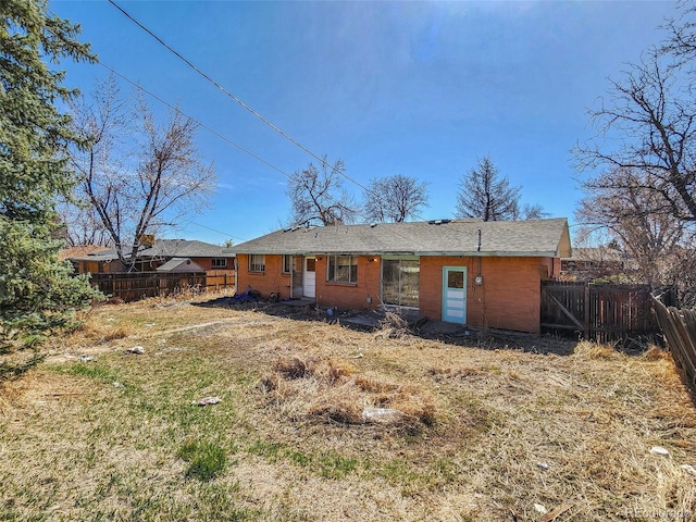 rear view of house featuring fence