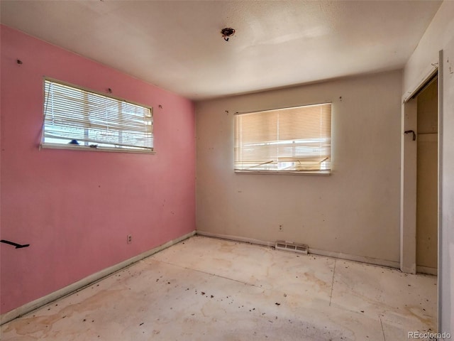 unfurnished bedroom featuring visible vents