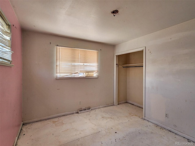 unfurnished bedroom featuring a closet and visible vents