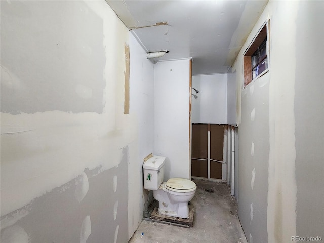 bathroom with toilet and concrete floors