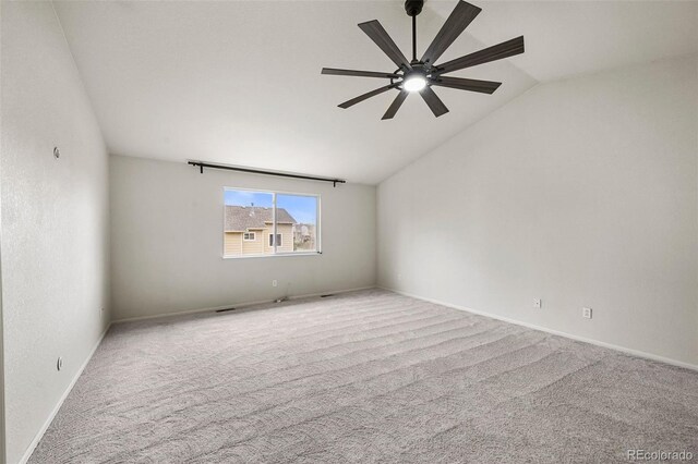 carpeted spare room with baseboards, a ceiling fan, and lofted ceiling