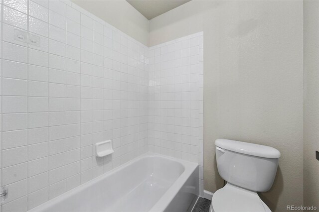 bathroom featuring baseboards and toilet