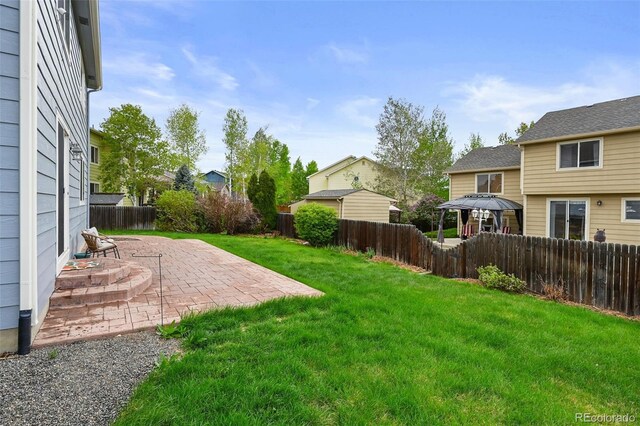 view of yard with a fenced backyard and a patio area