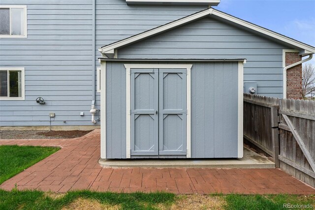 view of shed with fence