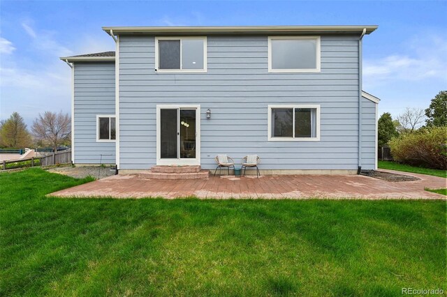 rear view of house featuring a patio area, fence, and a yard