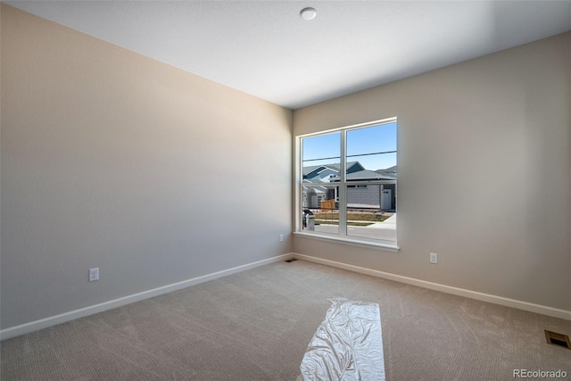 empty room with light colored carpet