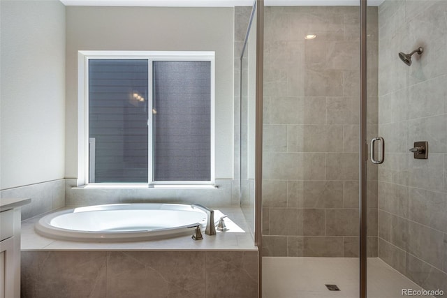 bathroom featuring vanity and shower with separate bathtub