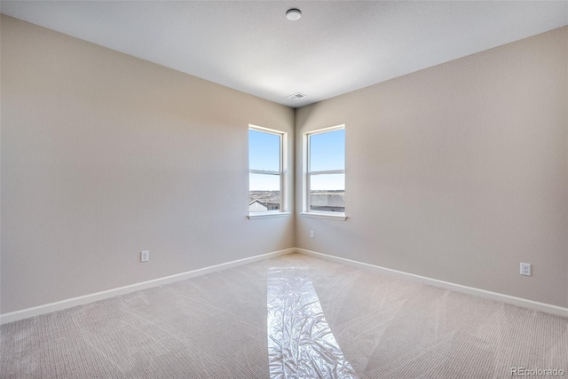 unfurnished room with light colored carpet