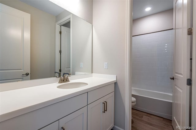 full bathroom featuring shower / bath combination, wood-type flooring, toilet, and vanity