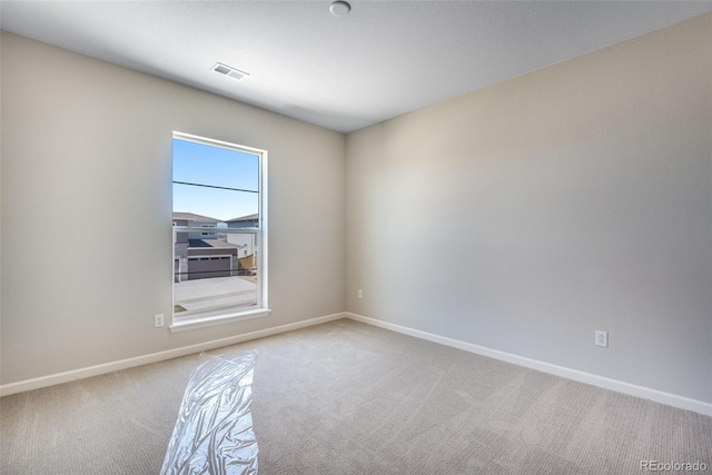 unfurnished room with light colored carpet