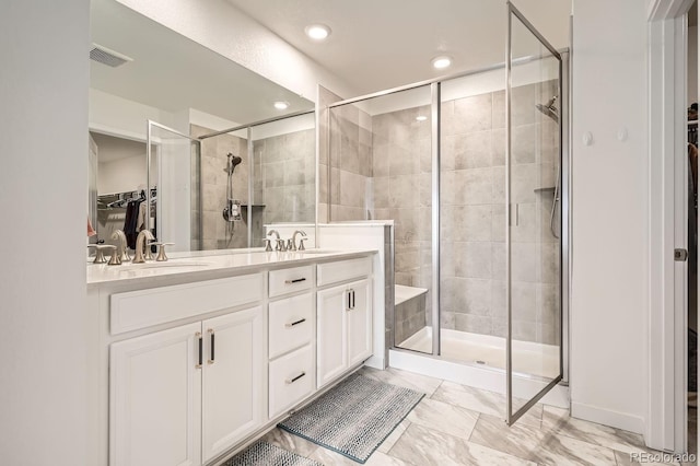 bathroom with walk in shower and vanity