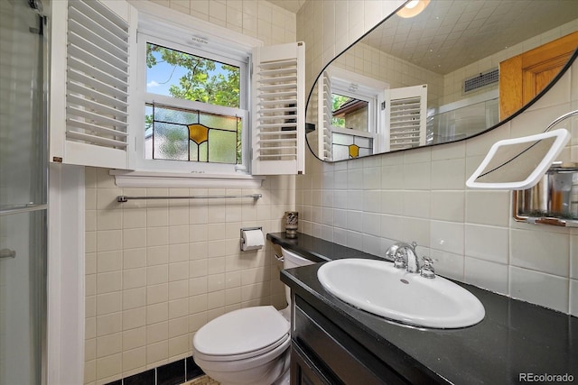 1040 N Kearney St, Denver, CO 80220 - full bath with tile walls, vanity, backsplash, and a shower with door