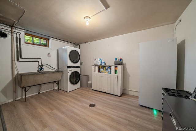 1040 N Kearney St, Denver, CO 80220 - laundry room with stacked washer / dryer and wood finished floors