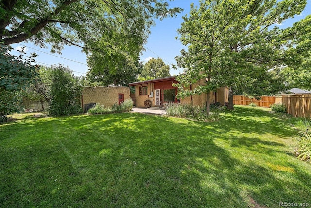 1040 N Kearney St, Denver, CO 80220 - fenced backyard featuring a patio area