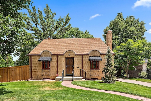 1040 N Kearney St, Denver, CO 80220 - tudor-style house with a chimney, brick siding, and roof with shingles