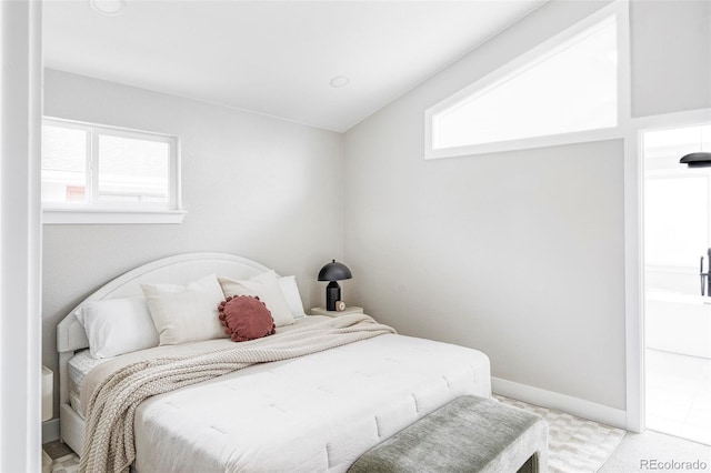 carpeted bedroom with lofted ceiling