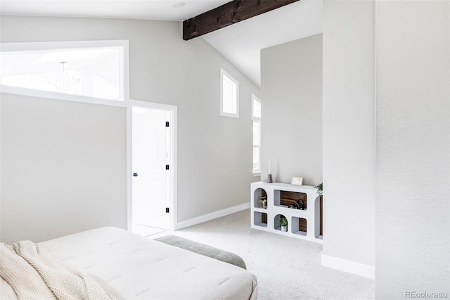 bedroom featuring light carpet and lofted ceiling with beams