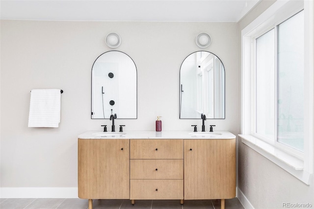 bathroom with tile patterned flooring and vanity