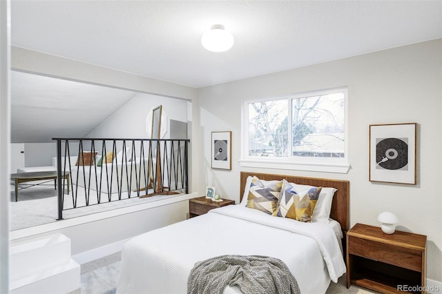 bedroom with carpet flooring and lofted ceiling