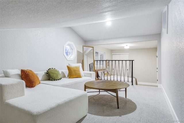 carpeted living room featuring lofted ceiling and a textured ceiling