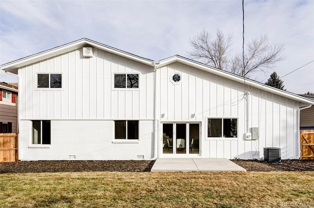 rear view of house featuring central air condition unit, a patio area, and a lawn