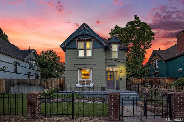 2831 N Humboldt St, Denver, CO 80205 - victorian house featuring a porch, brick siding, and a fenced front yard