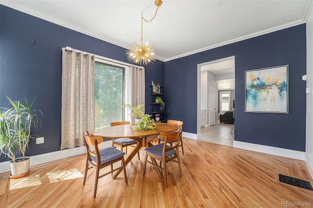 2831 N Humboldt St, Denver, CO 80205 - dining room with crown molding, light wood-style floors, and a chandelier