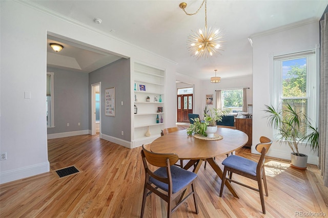 2831 N Humboldt St, Denver, CO 80205 - dining space with built in features, a chandelier, light wood-style flooring, and ornamental molding