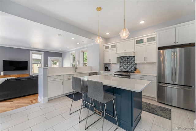 2831 N Humboldt St, Denver, CO 80205 - kitchen with stainless steel appliances, a peninsula, open floor plan, light countertops, and backsplash