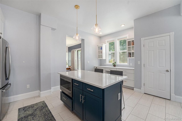 2831 N Humboldt St, Denver, CO 80205 - kitchen featuring appliances with stainless steel finishes, light countertops, white cabinetry, pendant lighting, and recessed lighting