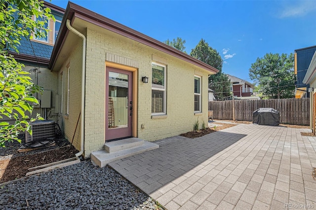 2831 N Humboldt St, Denver, CO 80205 - view of exterior entry featuring brick siding and a patio area