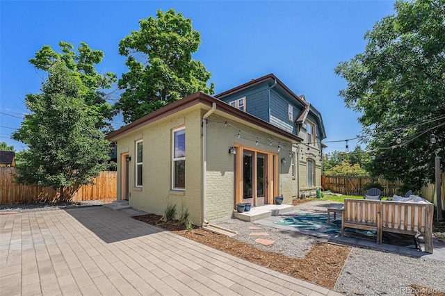 2831 N Humboldt St, Denver, CO 80205 - rear view of house featuring a fenced backyard, a deck, brick siding, and a patio