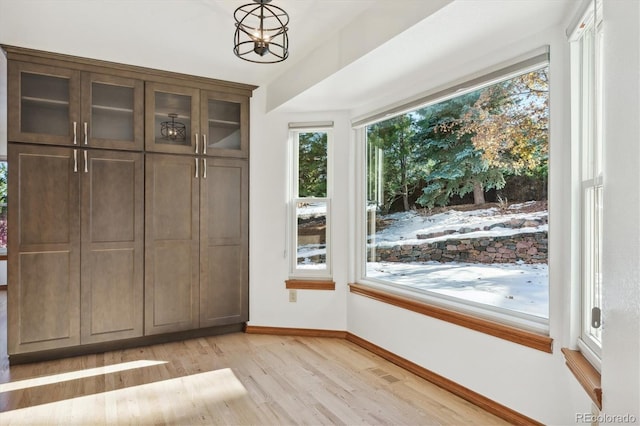 doorway with a chandelier and light hardwood / wood-style floors