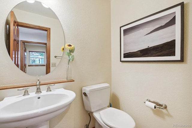 bathroom with toilet and sink