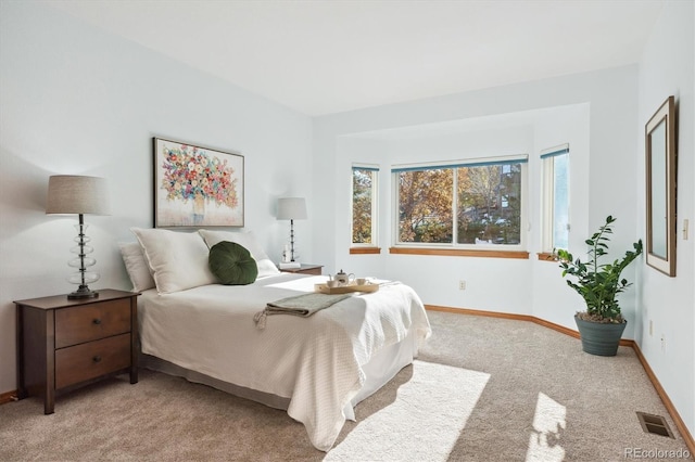 bedroom with light colored carpet