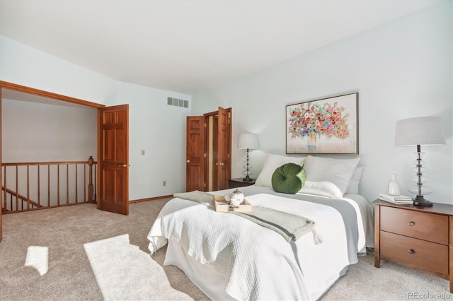 bedroom with light colored carpet