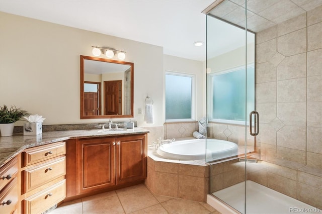 bathroom with tile patterned floors, vanity, and shower with separate bathtub