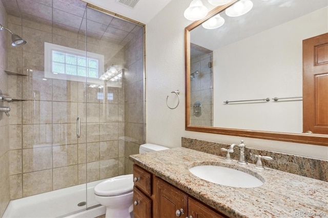 bathroom with vanity, toilet, and an enclosed shower