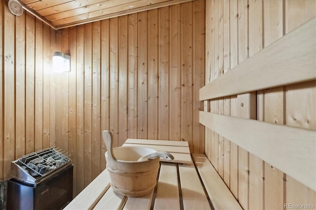 view of sauna with wood walls and wooden ceiling