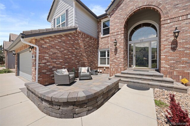 10 Sand Cherry, Littleton, CO 80127 - view of patio / terrace featuring driveway and an attached garage