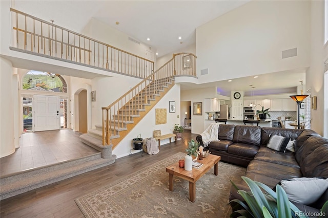 10 Sand Cherry, Littleton, CO 80127 - living room with a high ceiling, arched walkways, wood finished floors, and stairway